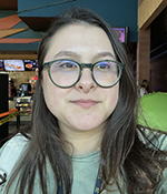 female with dark hair wearing green shirt